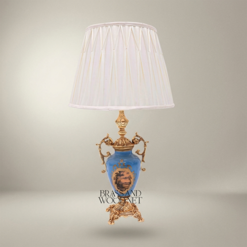 Classical Blue Porcelain Urn Table Lamp with Ornate Brass Scrollwork Handles and Hand-Painted Landscape Medallion White Pleated Shade Brass and Wood Gold Front | Brass & Wood