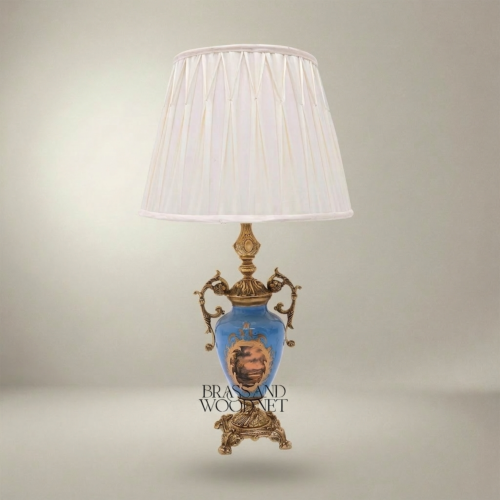 Classical Blue Porcelain Urn Table Lamp with Ornate Brass Scrollwork Handles and Hand-Painted Landscape Medallion White Pleated Shade Brass and Wood Antique Gold Front | Brass & Wood